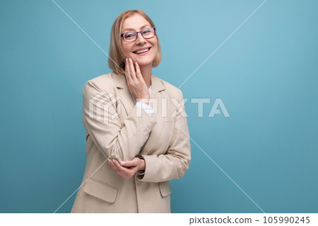 middle-aged business woman smiling in a jacket on a bright studio background with copy space middle-aged business woman smiling in a jacket on a bright studio background with copy space 105990245