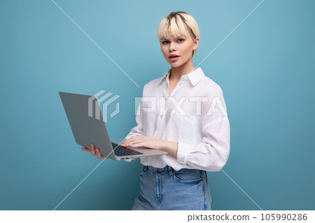 young successful blond student woman dressed in white blouse studying using laptop. education young successful blond student woman dressed in white blouse studying using laptop. education 105990286