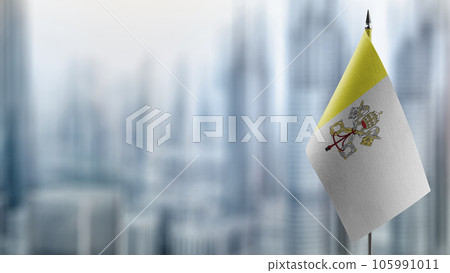 Small flags of the Vatican on an abstract blurry background 105991011