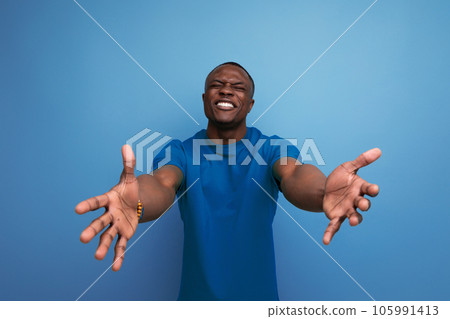 30 year old handsome american man dressed in a basic t-shirt shy closing his eyes 30 year old handsome american man dressed in a basic t-shirt shy closing his eyes 105991413