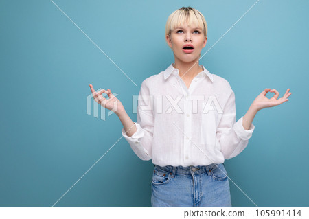 portrait of a young caucasian woman with a short haircut dressed in a white shirt among a blue portrait of a young caucasian woman with a short haircut dressed in a white shirt among a blue 105991414