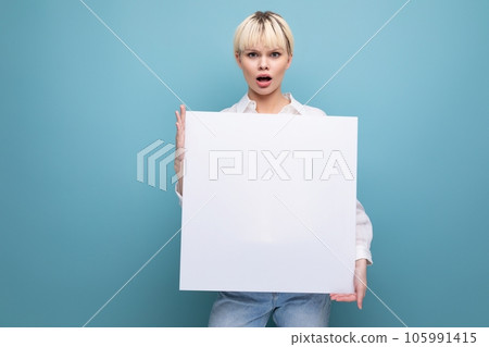 young pretty blond student woman dressed in a white blouse demonstrates her study project on a 105991415