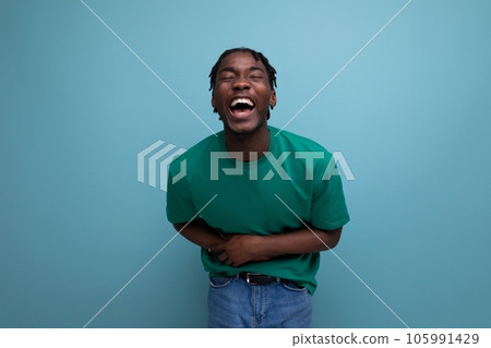funny laughing american young guy in a t-shirt on a blue background 105991429