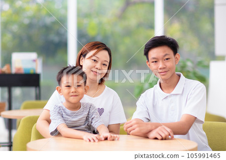 Mom and kids in restaurant. Asian family. Mom and kids in restaurant. Asian family. 105991465