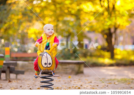 Child on playground in autumn. Kids in fall. 105991654