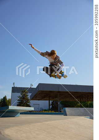 Roller skating concept, young male skater jumping high on ramp Roller skating concept, young male skater jumping high on ramp 105992208