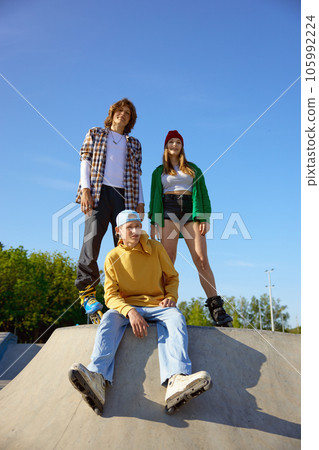 Group of professional teenager skaters sitting on ramp 105992224