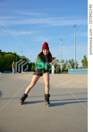 Healthy teenager girl enjoys rollerblading speed moves 105992246