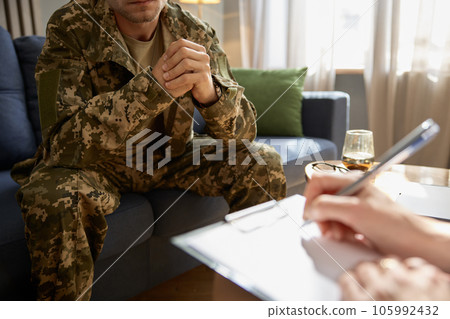 Closeup cropped shot of soldier visiting to psychologist for help and support 105992432