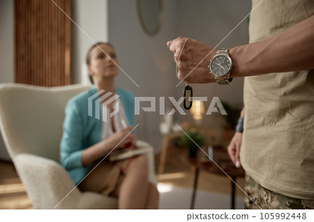 Psychological consultation, focus on military badge clenched in fist 105992448