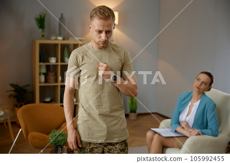 Male veteran suffering from ptsd crisis at psychological therapy session 105992455