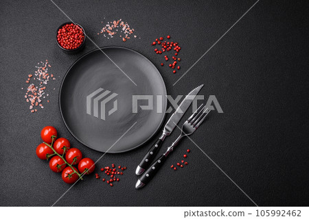 Empty black plate over dark stone background with copy space 105992462