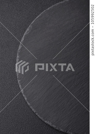 Empty black plate over dark stone background with copy space Empty black plate over dark stone background with copy space 105992502