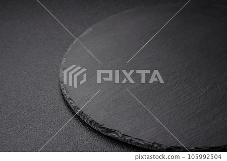 Empty black plate over dark stone background with copy space Empty black plate over dark stone background with copy space 105992504