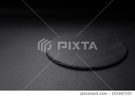 Empty black plate over dark stone background with copy space 105992505