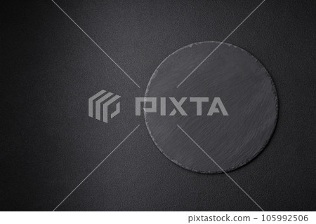 Empty black plate over dark stone background with copy space Empty black plate over dark stone background with copy space 105992506
