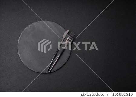Empty black plate over dark stone background with copy space 105992510