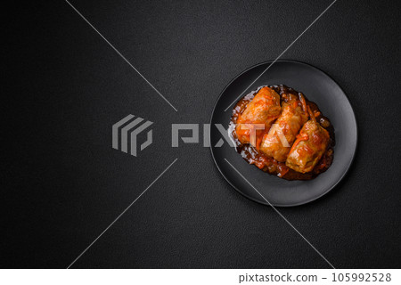 Delicious dolma in tomato sauce with carrots, onions, salt, spices and herbs 105992528