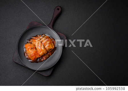 Delicious dolma in tomato sauce with carrots, onions, salt, spices and herbs 105992538