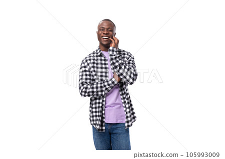 nice young american guy with short hair dressed casually holding a phone to his ear on a white 105993009
