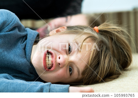 Two children boy and girl fooling around having fun together. Happy childhood concept. Two children boy and girl fooling around having fun together. Happy childhood concept. 105993765