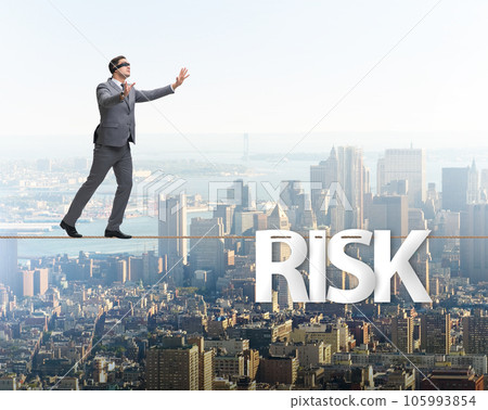 Businessman in risk concept walking on tight rope Businessman in risk concept walking on tight rope 105993854
