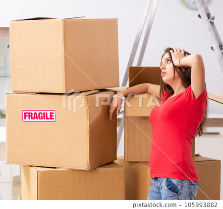 Young beautiful woman moving to new flat Young beautiful woman moving to new flat 105993882