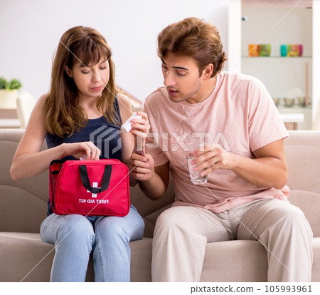 Young family getting treatment with first aid kit Young family getting treatment with first aid kit 105993961