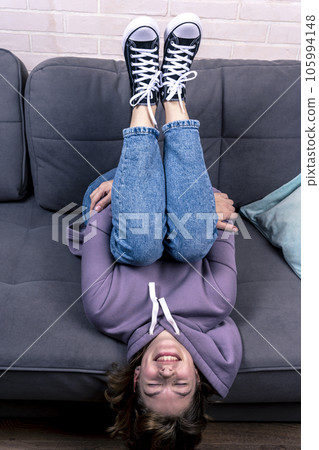 teenage girl, lying on the couch upside down teenage girl, lying on the couch upside down 105994148