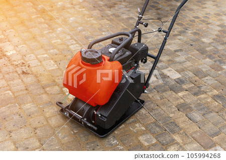 Gasoline Vibrating rammer with a vibrating plate on construction site 105994268
