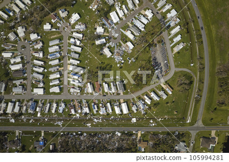Severely damaged houses after hurricane Ian in Florida mobile home residential area. Consequences of natural disaster 105994281