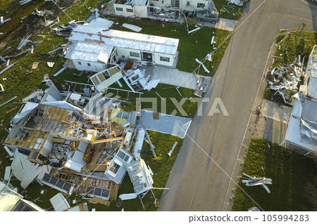 Severely damaged by hurricane Ian houses in Florida mobile home residential area. Consequences of natural disaster 105994283
