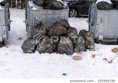 overflowing garbage containers on the site around which garbage overflowing garbage containers on the site around which garbage 105994294