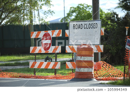 Road closed at construction site with protective fence barrier Road closed at construction site with protective fence barrier 105994349