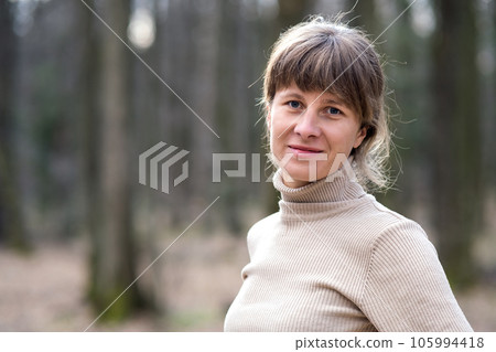 Portrait of young attractive woman enjoying warm day in early spring outdoors. 105994418