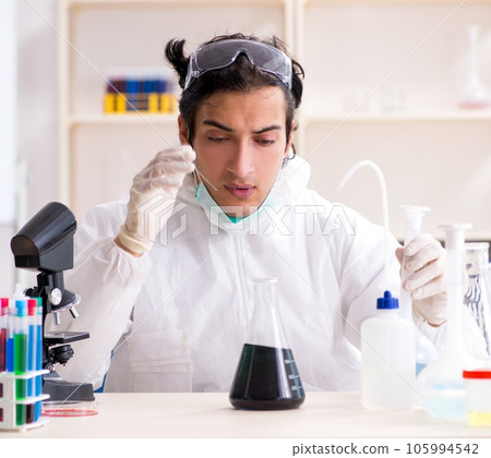 Young handsome chemist working in the lab Young handsome chemist working in the lab 105994542