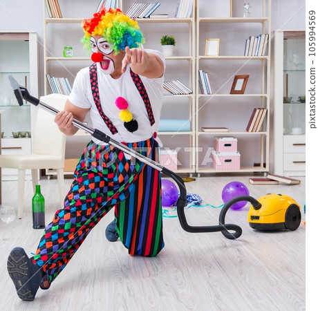 Funny clown doing cleaning at home 105994569