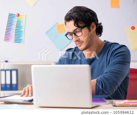 Young handsome designer working at the project Young handsome designer working at the project 105994612