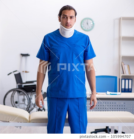 Young male doctor demonstrating the neck brace 105994707