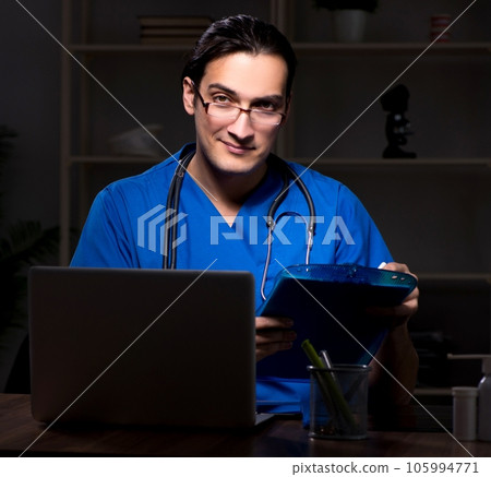 Young male doctor in the hospital at night Young male doctor in the hospital at night 105994771