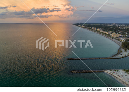 Nokomis beach with soft white sand and North and South Jetty in Sarasota county, USA. Many people enjoing vacation time bathing in warm gulf water and tanning under hot Florida sun at sunset 105994885