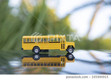 Little model of american yellow school bus outdoor. Concept of education safety in the USA Little model of american yellow school bus outdoor. Concept of education safety in the USA 105994915