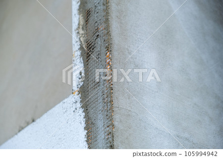 Installation of styrofoam insulation sheets on house facade wall for thermal protection. Installation of styrofoam insulation sheets on house facade wall for thermal protection. 105994942