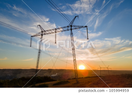 High voltage tower with electric power lines at sunset. Transmission of electricity 105994959
