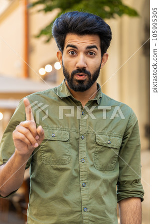 Displeased upset indian arabian man reacting to unpleasant awful idea wave hand finger shake head No 105995305