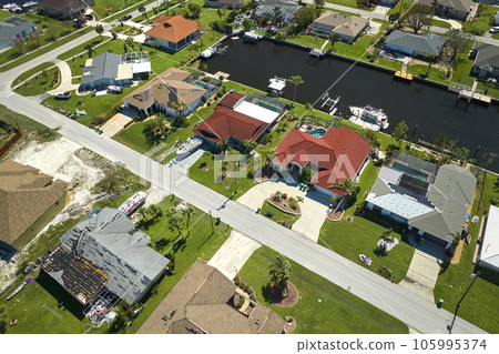 Damaged home rooftops after hurricane Ian in Florida coastal residential area. Consequences of natural disaster 105995374