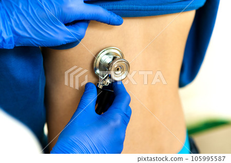 Closeup detail of doctor hand examining ill child with stethoscope. 105995587
