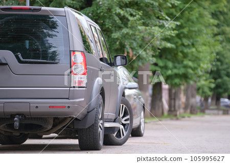Close up of a car parked on city street side. Urban traffic concept Close up of a car parked on city street side. Urban traffic concept 105995627
