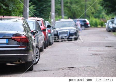 Cars parked in line on city street side. Urban traffic concept 105995645