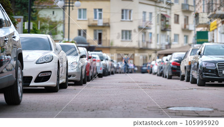 Cars parked in line on city street side. Urban traffic concept Cars parked in line on city street side. Urban traffic concept 105995920